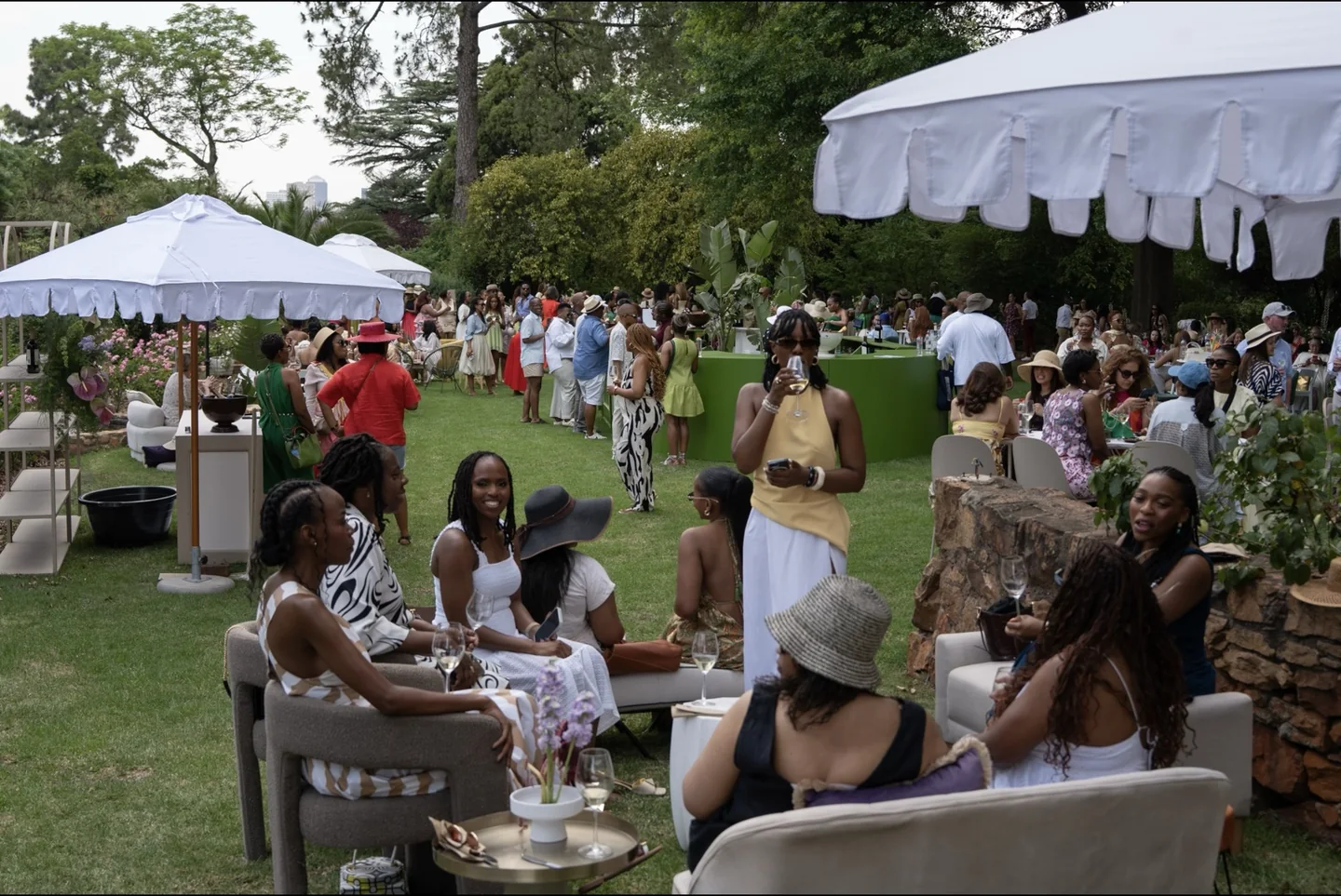 Guests gathered for an outdoor celebration among green trees